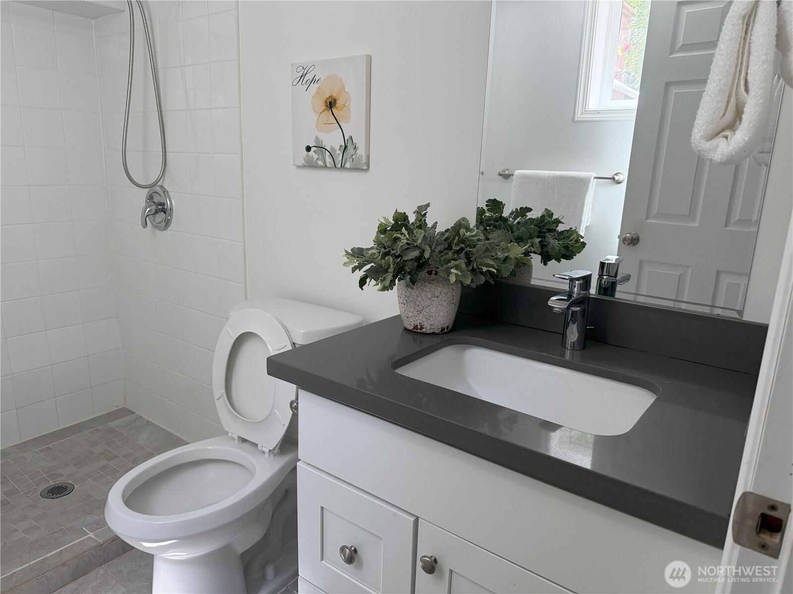4329 Northeast 56th Street Seattle, WA 98105 - Photo 21 of 34 a bathroom with a sink a toilet and a mirror