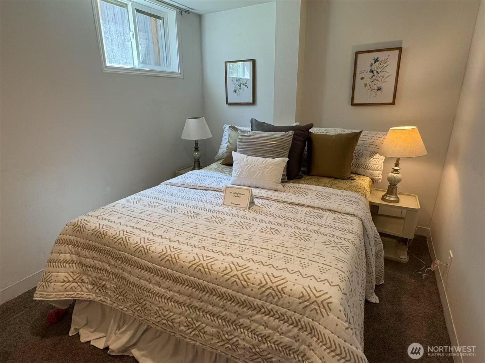 4329 Northeast 56th Street Seattle, WA 98105 - Photo 23 of 34 a large bed sitting in a bedroom next to a window with a lamp on table and a lamp