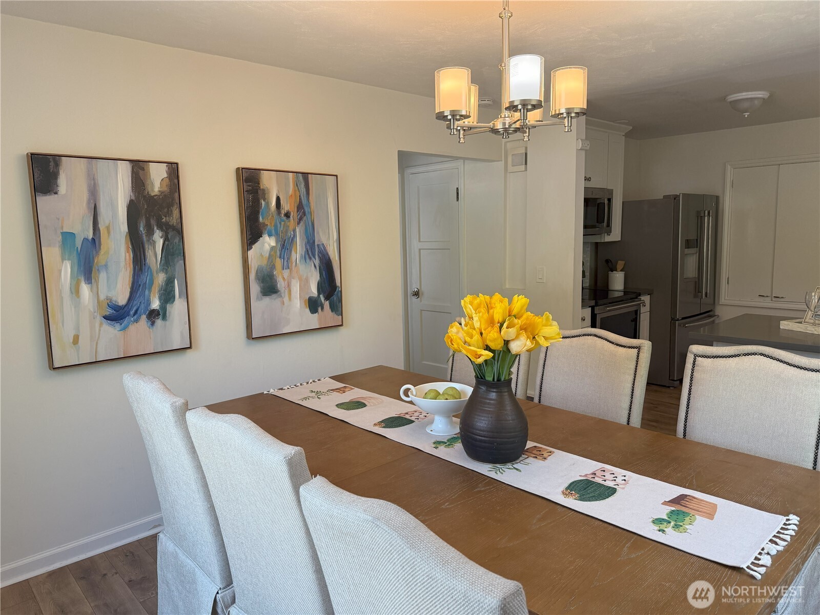 4329 Northeast 56th Street Seattle, WA 98105 - Photo 8 of 34 a dining room with furniture and chandelier