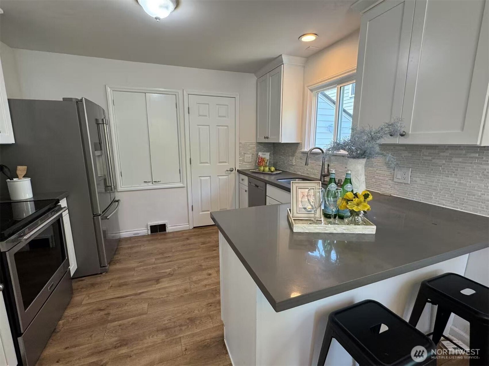 4329 Northeast 56th Street Seattle, WA 98105 - Photo 10 of 34 a kitchen with a sink appliances and cabinets