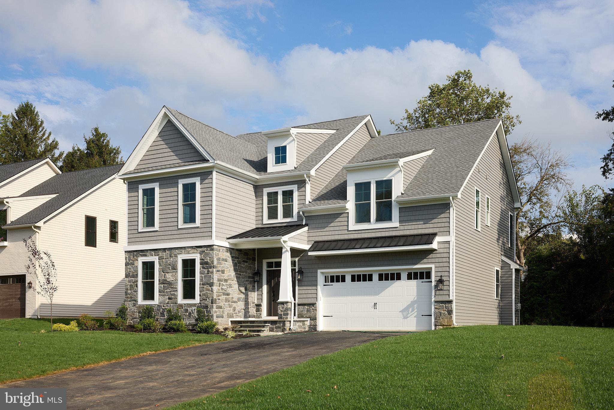 416 Glenway Road Glenside, PA 19038 - Photo 1 of 19 a view of a white house with a yard and table and chairs under an umbrella