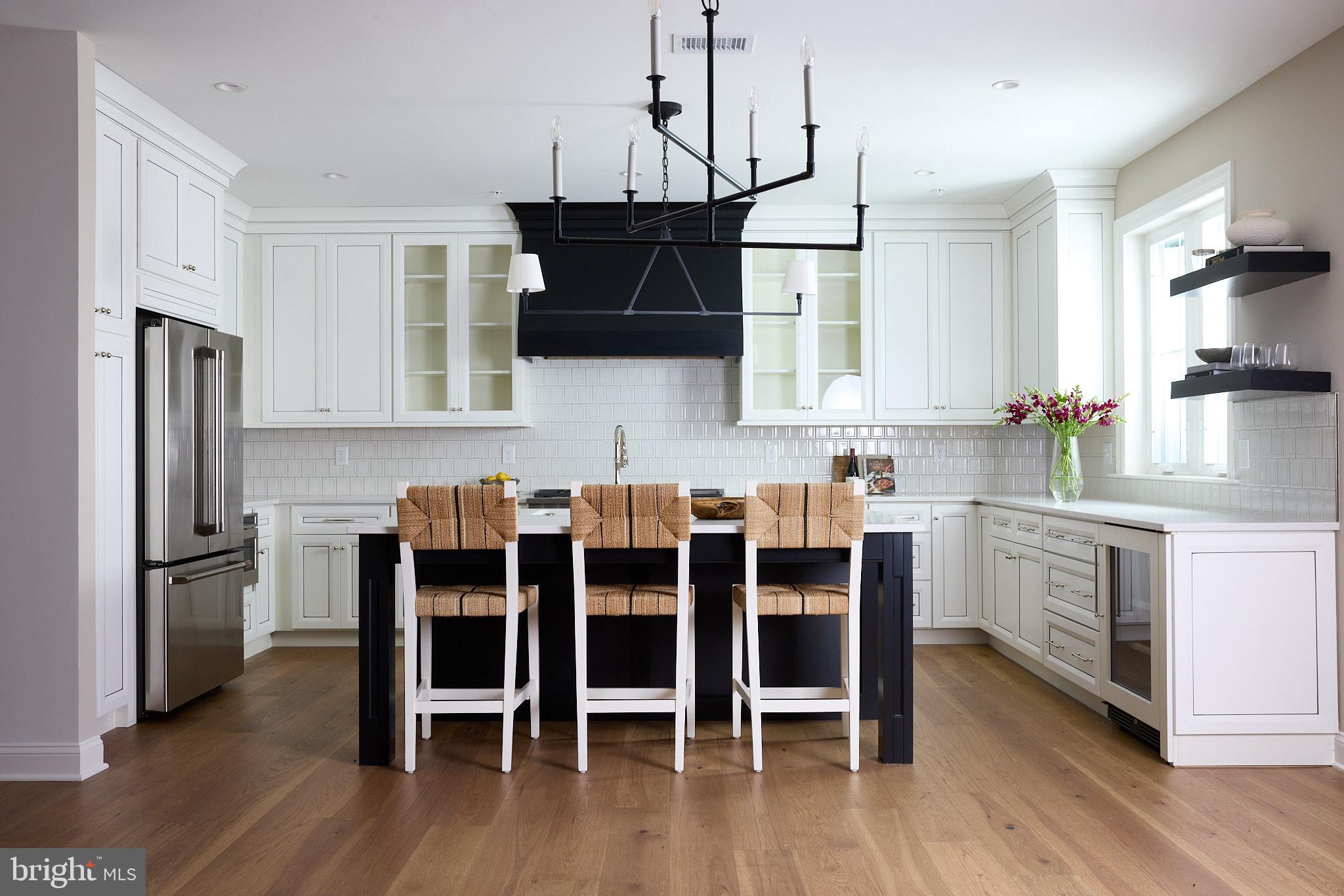 416 Glenway Road Glenside, PA 19038 - Photo 5 of 19 a kitchen with stainless steel appliances granite countertop a refrigerator a stove microwave and cabinets with wooden floor