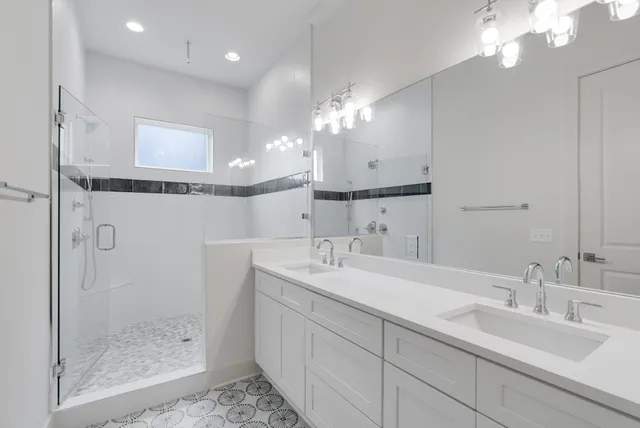 a bathroom with double sink and a mirror