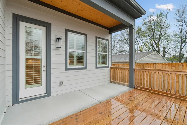 a view of balcony with wooden floor and fence