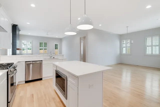 a kitchen with a stove a sink and a refrigerator