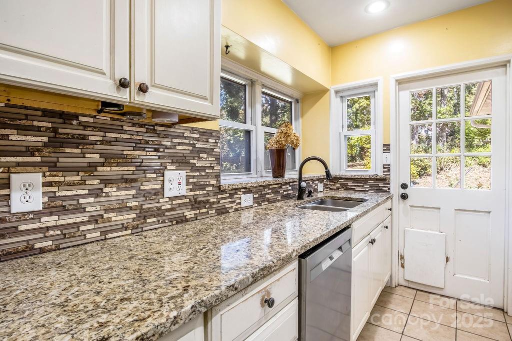 145 Beverly Road Asheville, NC 28805 - Photo 13 of 45 a kitchen with granite countertop sink and cabinets