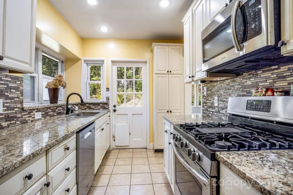 145 Beverly Road Asheville, NC 28805 - Photo 15 of 45 a kitchen with stainless steel appliances granite countertop a stove and a sink
