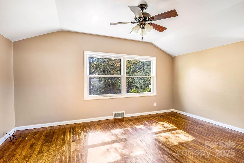 145 Beverly Road Asheville, NC 28805 - Photo 18 of 45 a view of a room with a window and a ceiling fan