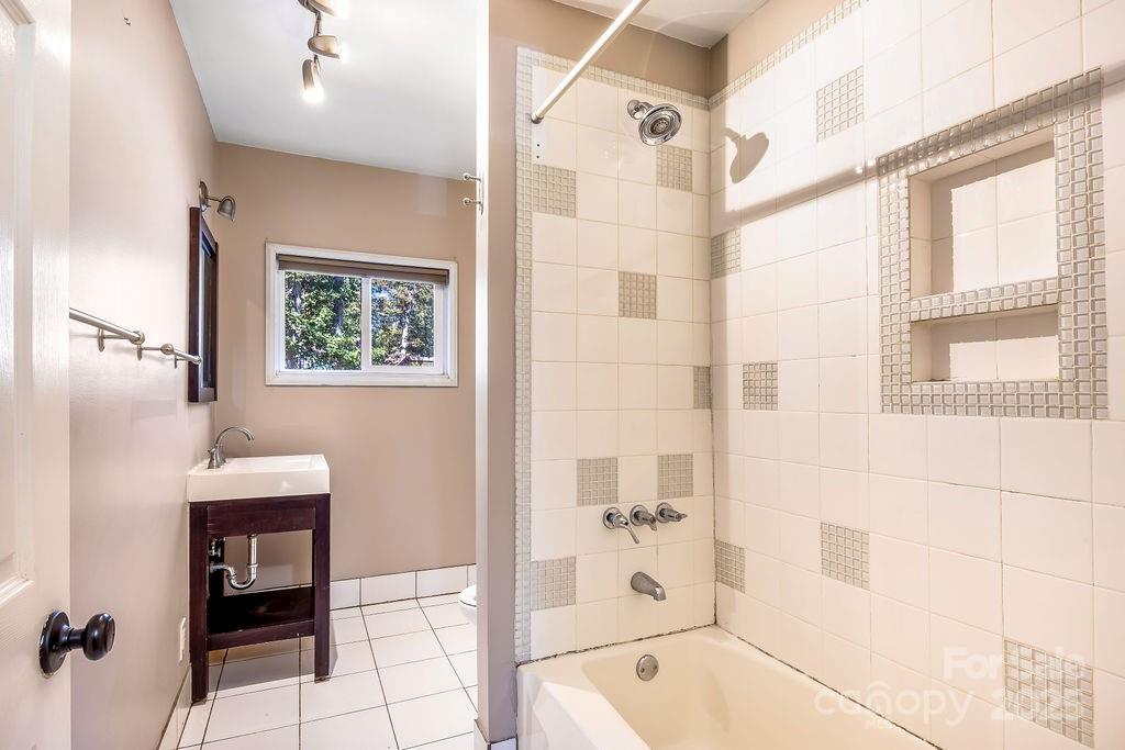 145 Beverly Road Asheville, NC 28805 - Photo 21 of 45 a bathroom with a bathtub and window