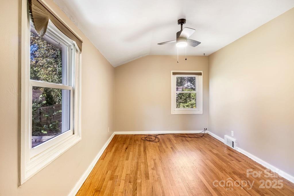 145 Beverly Road Asheville, NC 28805 - Photo 23 of 45 a view of empty room with wooden floor and fan