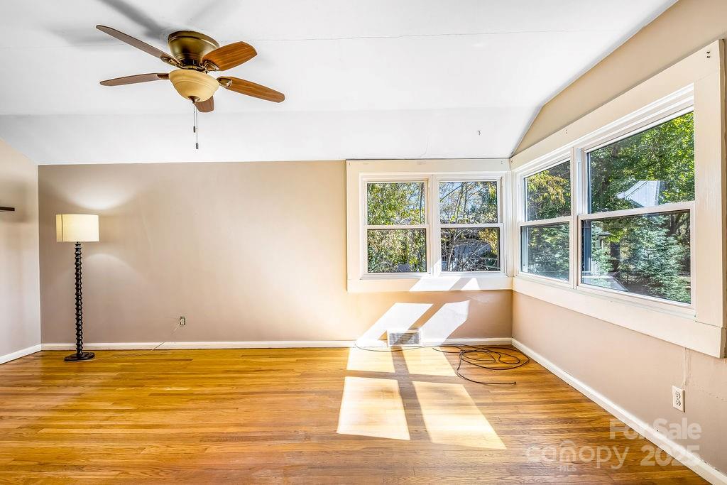145 Beverly Road Asheville, NC 28805 - Photo 26 of 45 a view of a room with wooden floor and a ceiling fan
