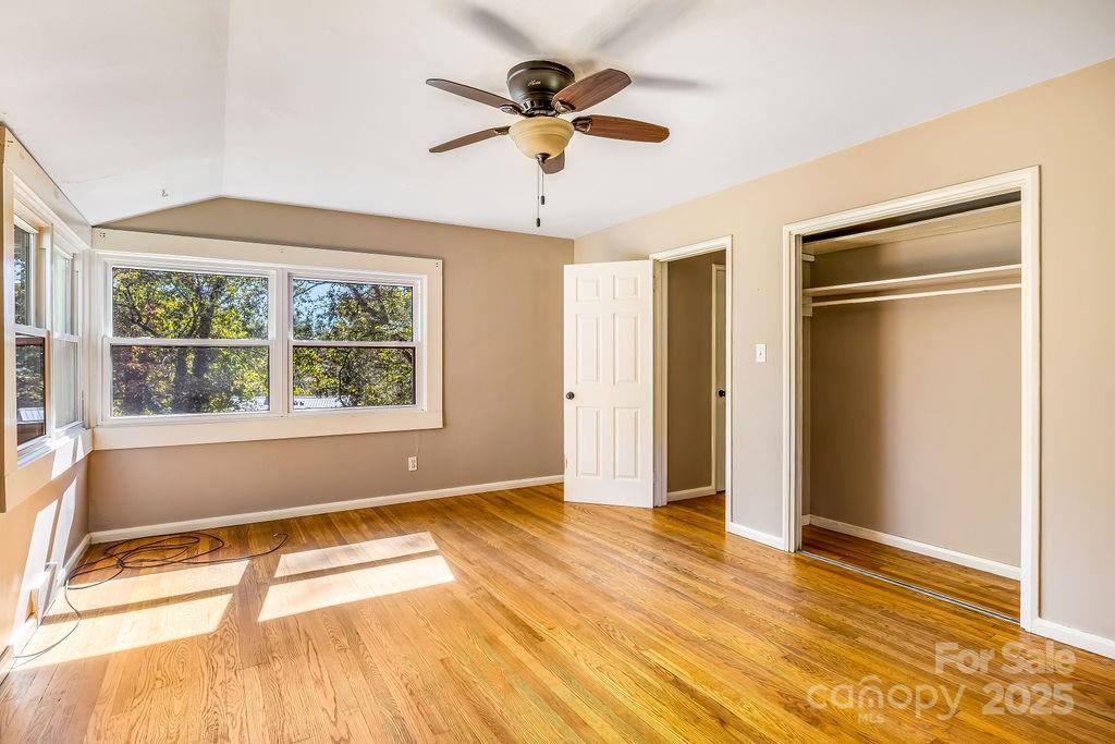 145 Beverly Road Asheville, NC 28805 - Photo 28 of 45 a view of an empty room with wooden floor and a window