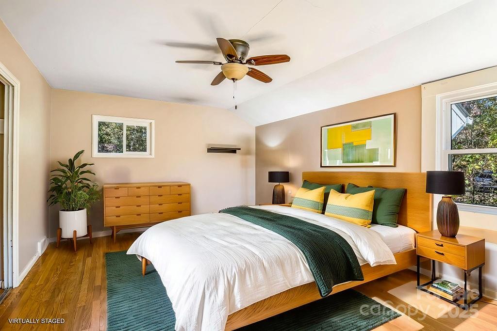 145 Beverly Road Asheville, NC 28805 - Photo 34 of 45 a bedroom with a bed and wooden floor