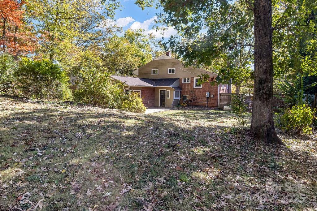 145 Beverly Road Asheville, NC 28805 - Photo 40 of 45 a view of a house with a tree and a yard