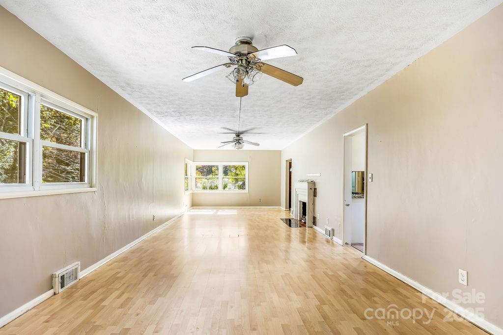145 Beverly Road Asheville, NC 28805 - Photo 8 of 45 a view of a livingroom with a window and wooden floor