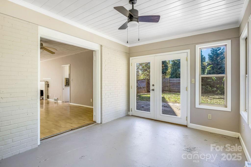 145 Beverly Road Asheville, NC 28805 - Photo 10 of 45 an empty room with chandelier fan and windows