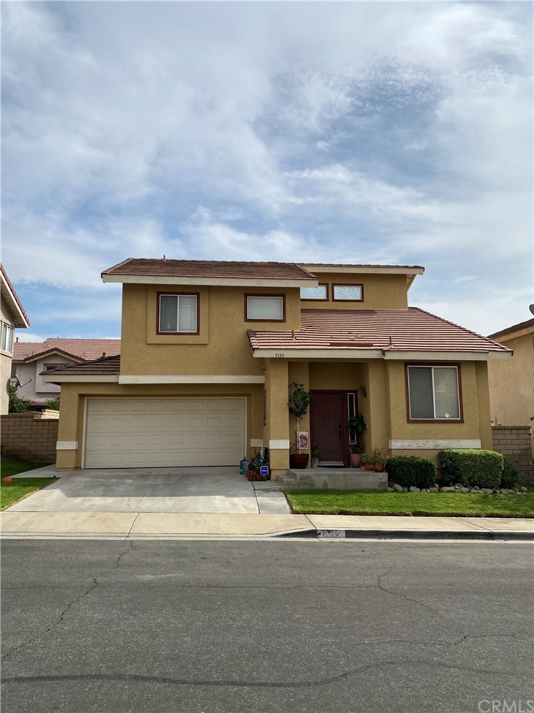 7155 Riva Place Rancho Cucamonga, CA 91701 - Photo 1 of 1 a front view of a house with a yard and garage
