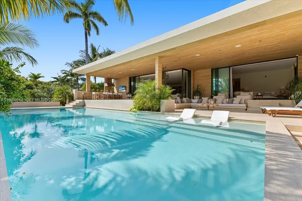 a swimming pool with outdoor seating and yard