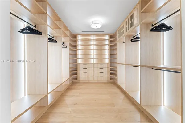 a view of walk in closet with empty racks