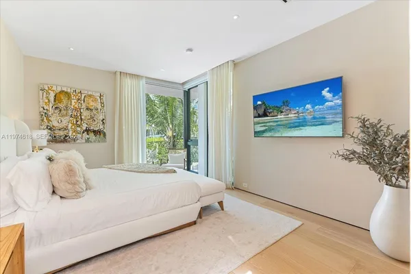 a bedroom with a bed and a painting on the wall
