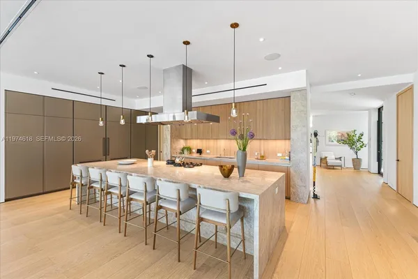 a dining room filled with furniture and wooden floor