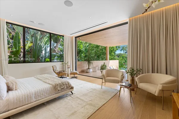 a bedroom with a bed and a large window