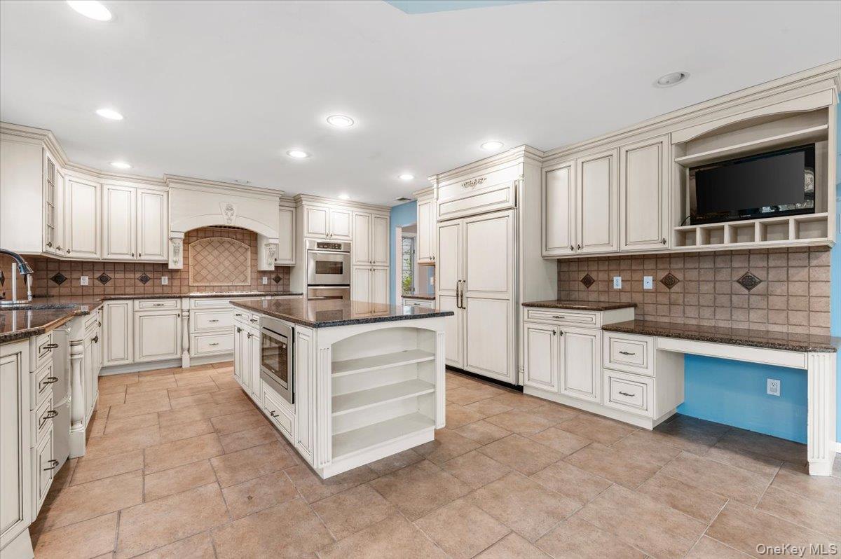 Undisclosed Address Bellmore, NY 11710 - Photo 11 of 30 a large white kitchen with stainless steel appliances granite countertop a stove a sink and a microwave