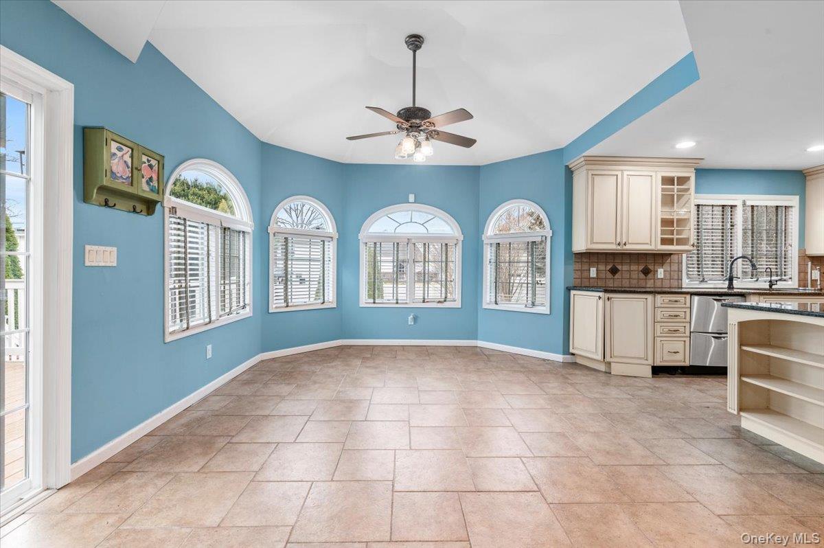 Undisclosed Address Bellmore, NY 11710 - Photo 13 of 30 a view of a kitchen with a kitchen island granite countertop stainless steel appliances cabinets a dining table and a window