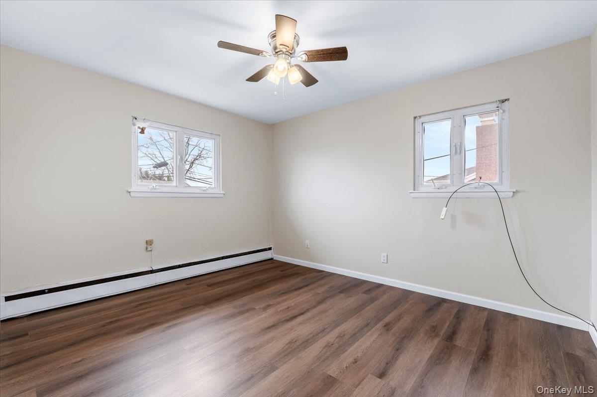 Undisclosed Address Bellmore, NY 11710 - Photo 18 of 30 wooden floor in an empty room with a window
