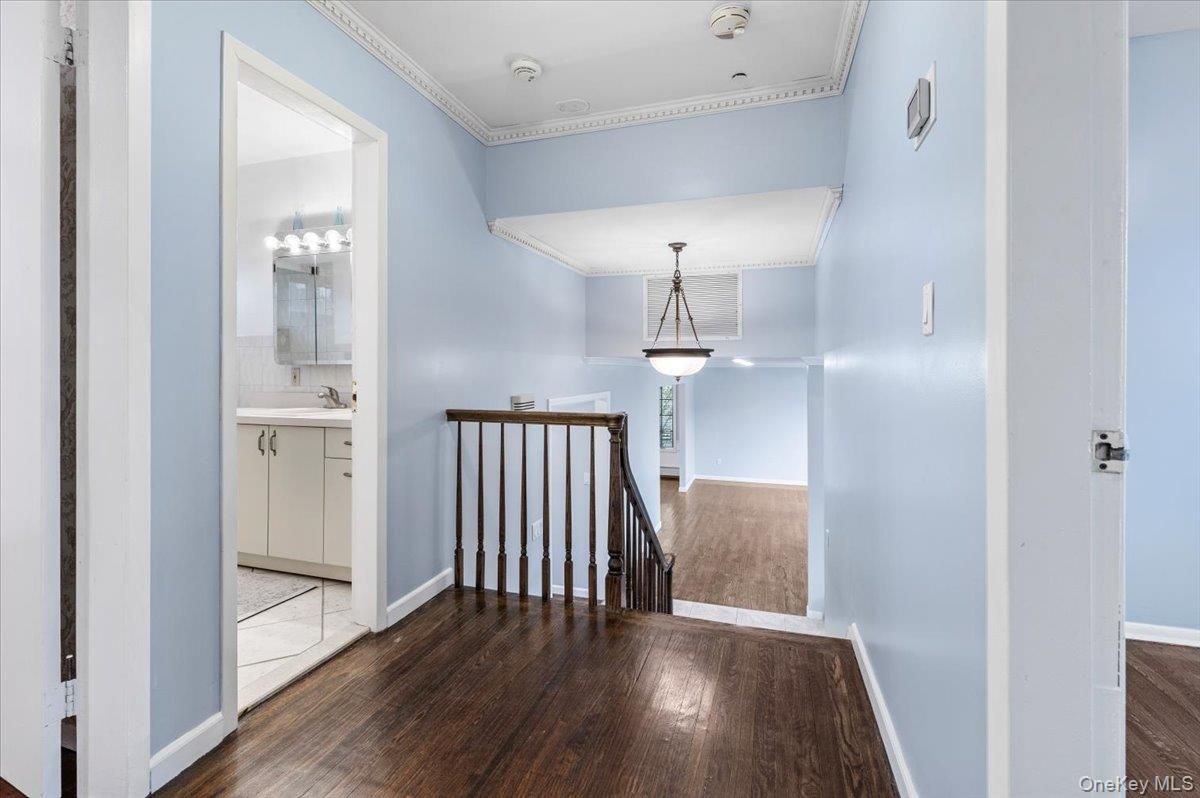 Undisclosed Address Bellmore, NY 11710 - Photo 20 of 30 a view of a hallway with wooden floor and staircase