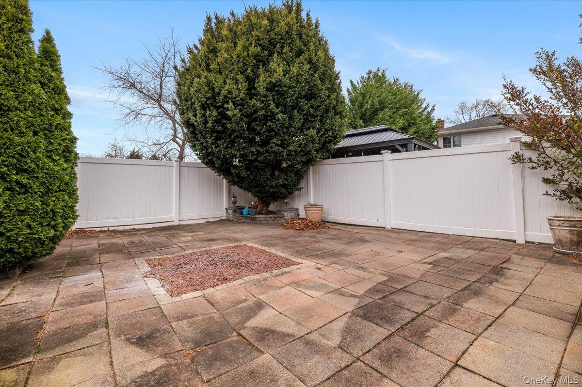 Undisclosed Address Bellmore, NY 11710 - Photo 28 of 30 a view of a house with a yard and garage