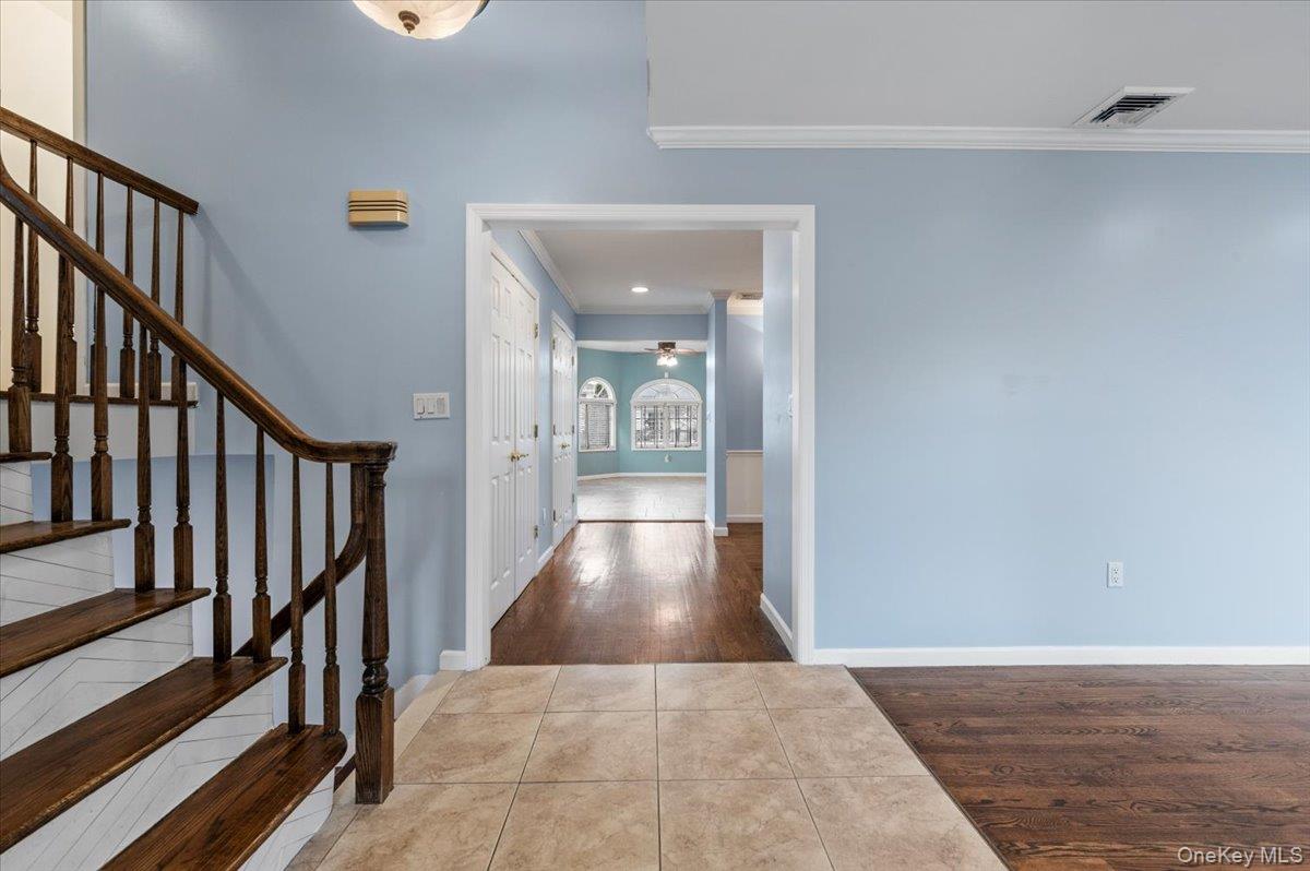 Undisclosed Address Bellmore, NY 11710 - Photo 3 of 30 a view of a hallway view with wooden floor and staircase