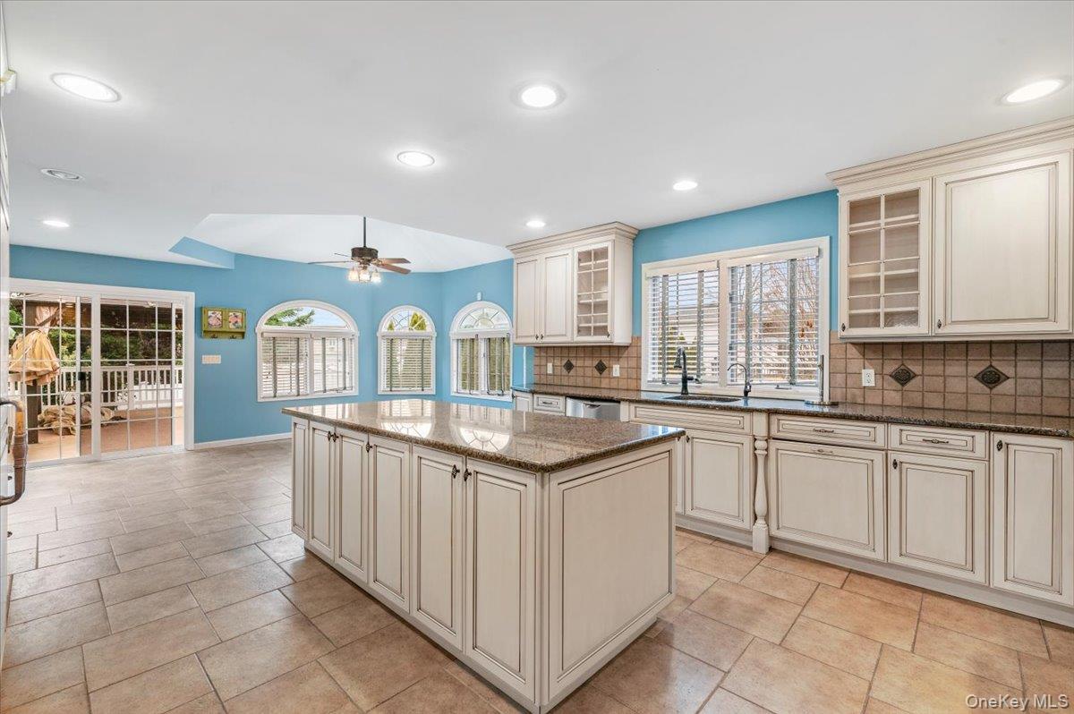 Undisclosed Address Bellmore, NY 11710 - Photo 9 of 30 a kitchen with granite countertop stove sink and cabinets