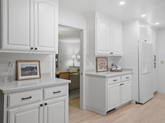 a dining room with furniture a chandelier and wooden floor