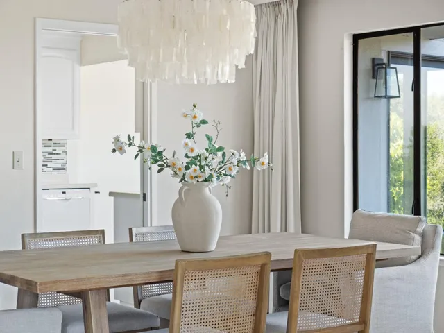 a spacious bedroom with a bed and a lamp