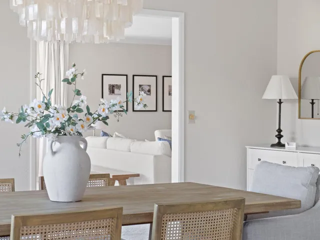 a bedroom with a bed and potted plant