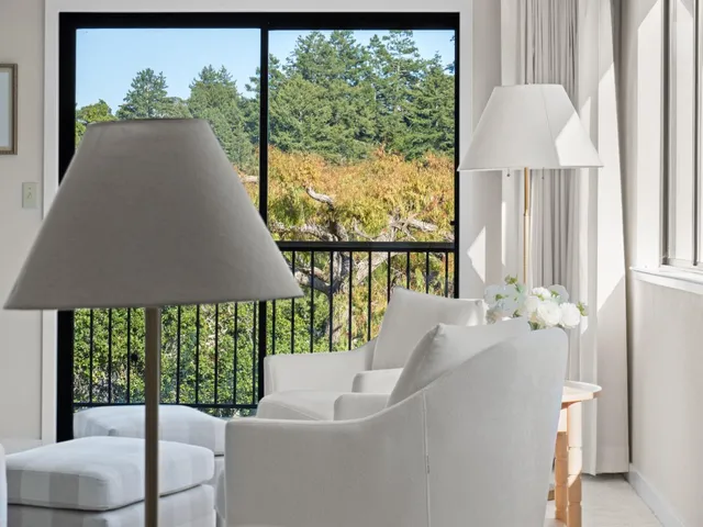 a spacious bedroom with a bed and a lamp