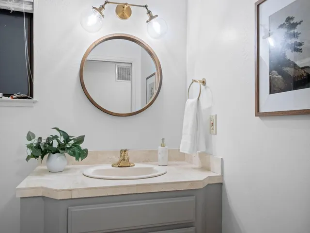 a bathroom with a bathtub and a flat screen tv