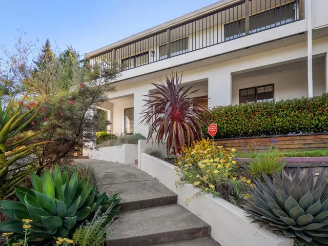 a front view of a house with a yard and a garage