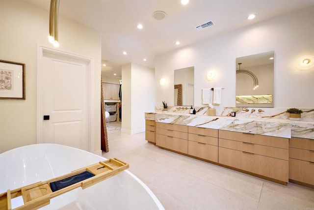 a large bedroom with a bed and a large mirror