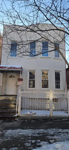 a view of a brick house with a small yard