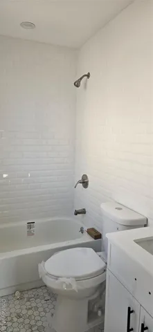 a bathroom with a sink a toilet and bathtub