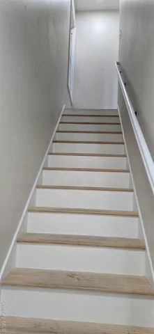 a view of staircase with white walls