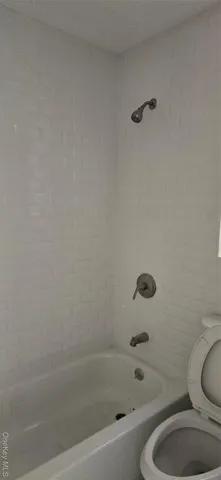 a bathroom with a sink a toilet and bathtub