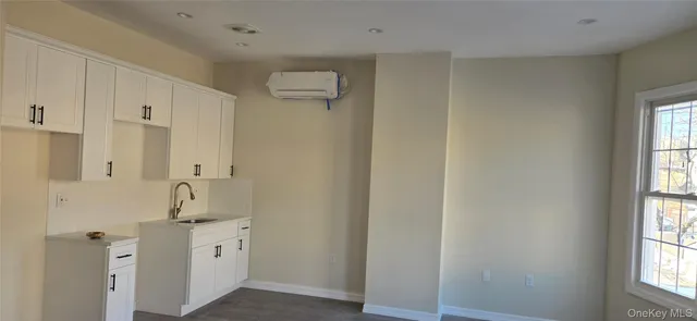a bathroom with double vanity sink a mirror and a shower