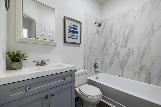 a bathroom with a sink a toilet and a tub