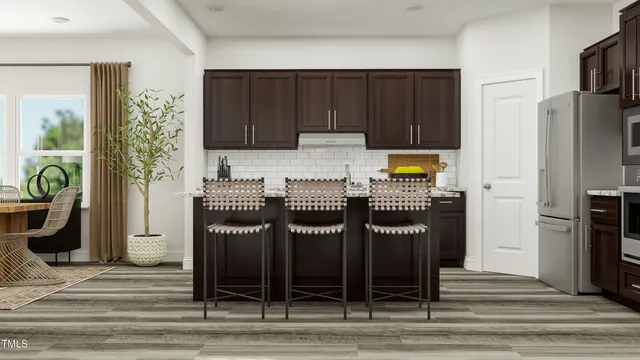 a kitchen with stainless steel appliances granite countertop a refrigerator and a stove top oven