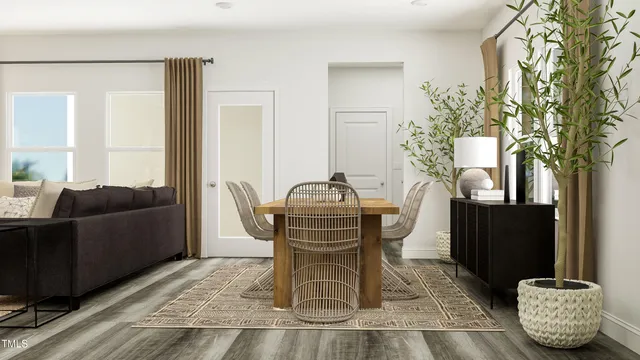 a living room with furniture and a potted plant