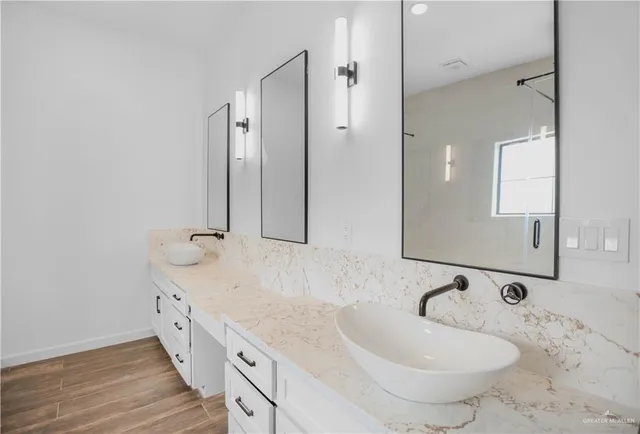 a bathroom with a double vanity sink and mirror