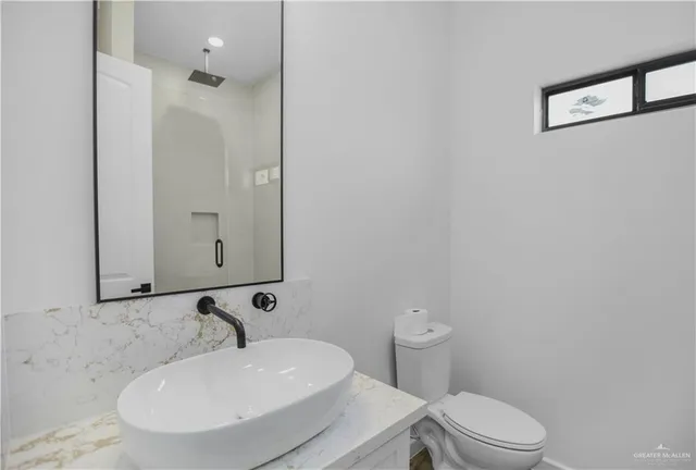 a bathroom with a glass shower door